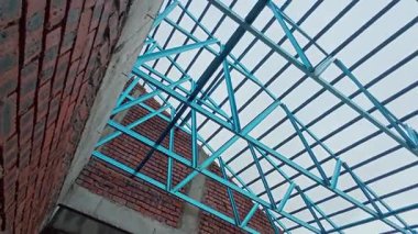 Çatı iskeleti yapımında kullanılan hafif alüminyum çelik kirişe bakıyorum..