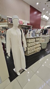 Perak, Malaysia. September 16,2025: Islamic Malay textile clothes for man,woman and children on sales and displays at some of the store at Aeon Mall,Sri Manjung.  