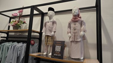 Perak, Malaysia. September 16,2025: Islamic Malay textile clothes for man,woman and children on sales and displays at some of the store at Aeon Mall,Sri Manjung.  