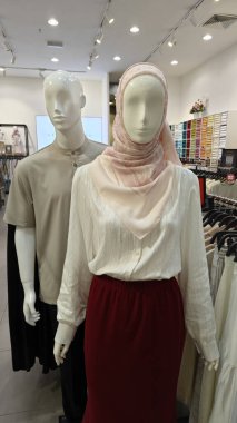 Perak, Malaysia. September 16,2025: Islamic Malay textile clothes for man,woman and children on sales and displays at some of the store at Aeon Mall,Sri Manjung.  