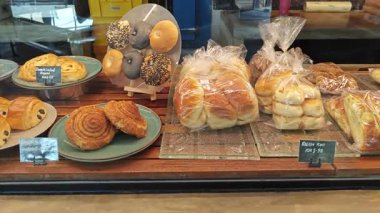 Perak, Malaysia. September 18, 2025: Varieties of bread, pastry and cake on display and sale in the glass shelves at the Noah's Roastry cafe,Sitiawan. 
