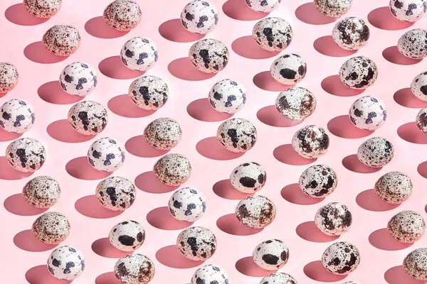 collection of little quail eggs isolated on pink background