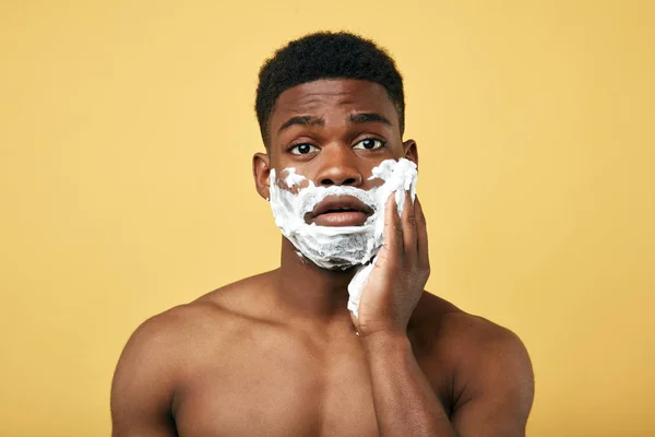 Puzzled African man going to shave beard