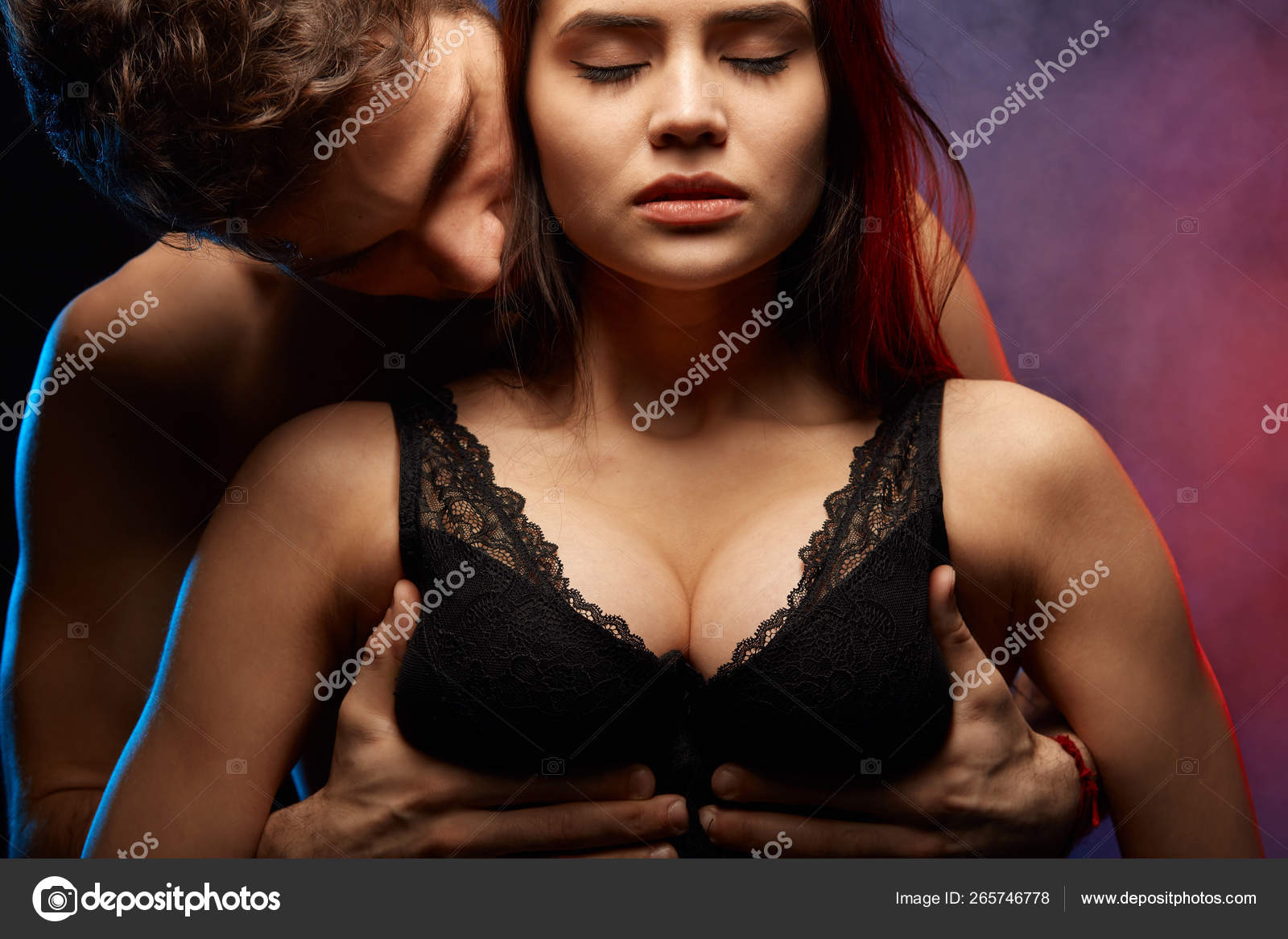 handsome man is holding woman's breast in hands and kissing her in the  neck. close up photo Stock Photo - Alamy