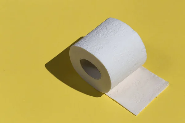 Roll of toilet paper or tissue isolated on yellow background — Stock Photo, Image