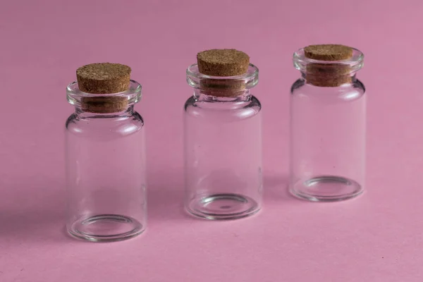 Empty glass medical bottles for injection on the red background