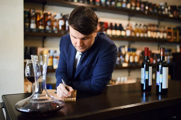 young fashionable man planning the wine menu