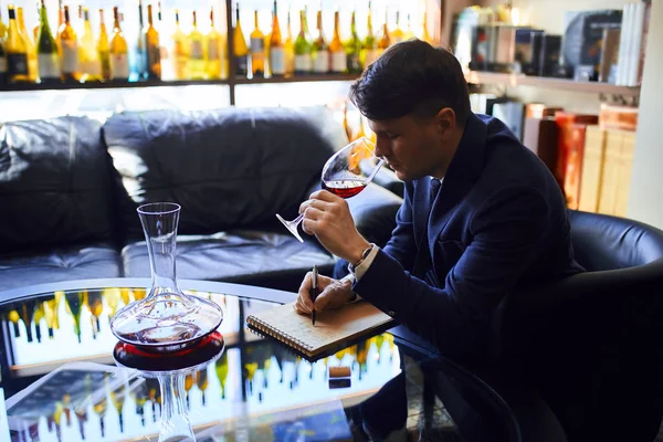 building a great wine list. young attractive man giving recommendation of wine