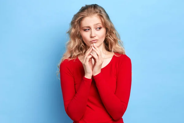 Dreamy thoughtful girl smiles gently, keeps hand together under chin. — Stock Photo, Image