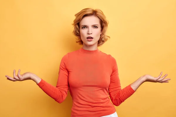 Young woman shrugging shoulders, being surprised by results of exam — Stock Photo, Image