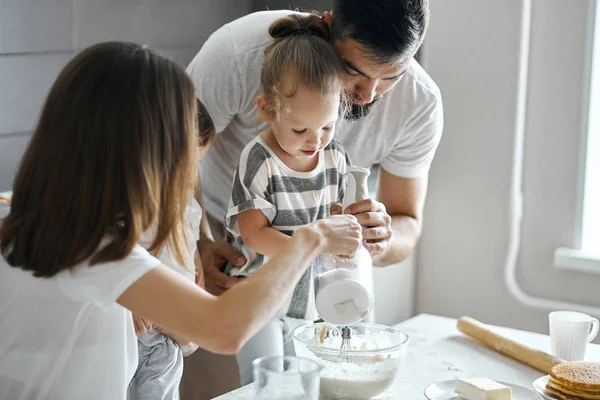 Little child making dough with parents — Stock Photo, Image
