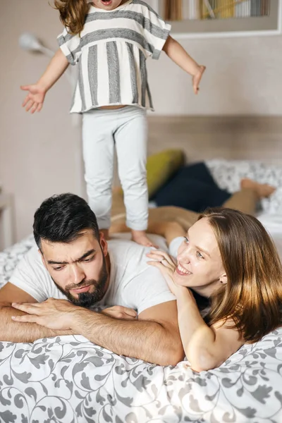babasının sırtında duran açık saçlı kız