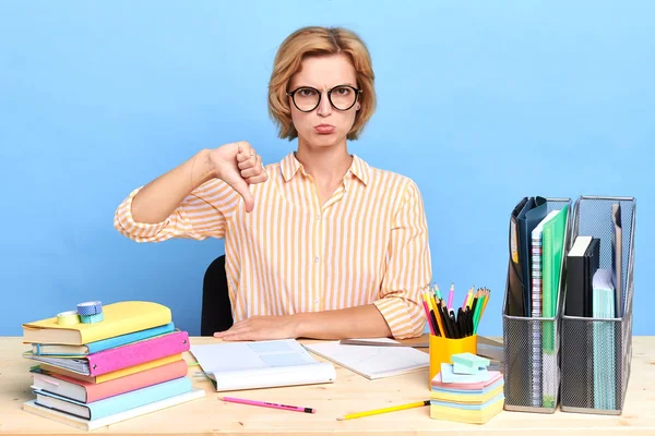 unhappy sad depressed office worker showing thumb down