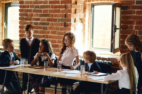 little school children discussing project