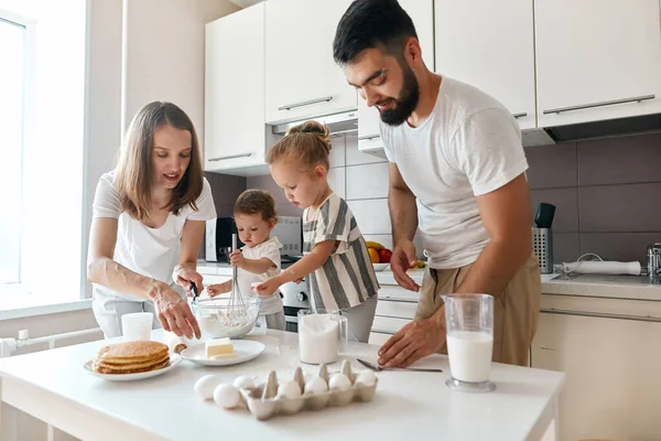United young family concentrated on cooking process — Stock Photo, Image