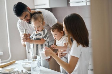 Sarışın küçük kız kahvaltı hazırlarken blender kullanıyor.