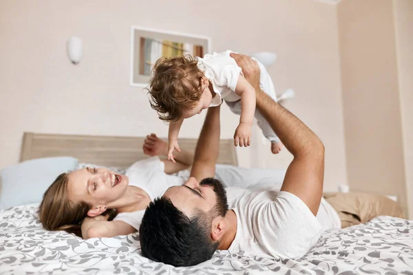 Positive couple entertaining their baby — Stock Photo, Image