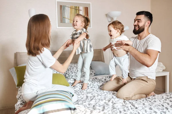 Mother, father and their adorable kids playing together. — Stock Photo, Image