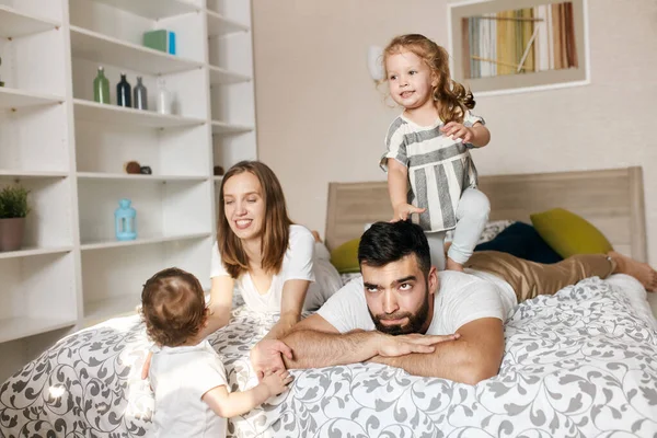 Serious man is tired to lok after his kids — Stock Photo, Image