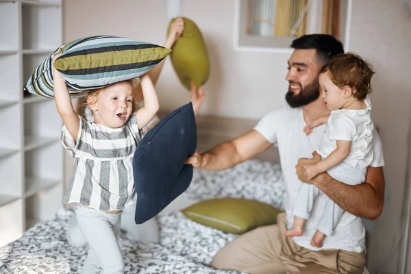 Happy family fighting with pillows