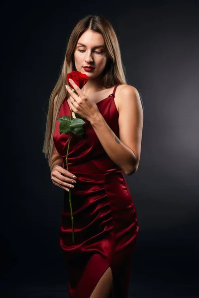 blonde woman enjoying wonderful smell of rose from her boyfriend