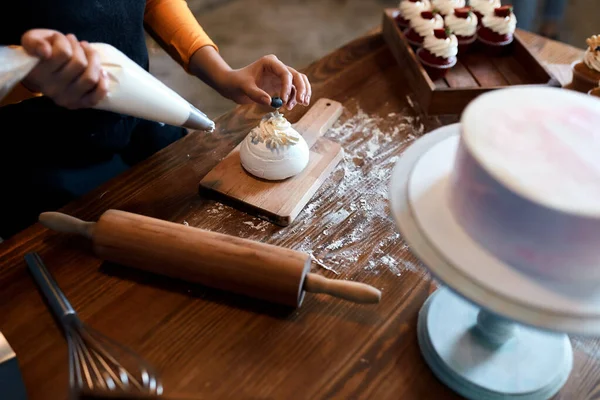 talented chef concentrated on cooking cup cakes for sale