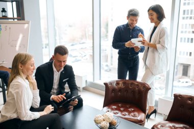 Ofiste çalışmaktan keyif alan dört pozitif genç.