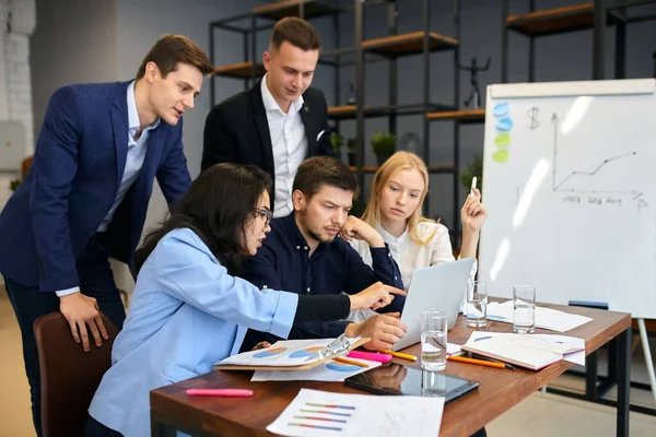 Jeunes employés de bureau utilisant un ordinateur portable sur le lieu de travail — Photo