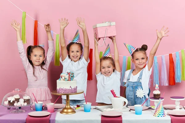 stock image little girl raising her present being happy to receive a gift