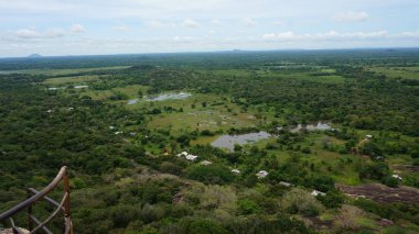 Orman, çeltik tarlaları ve antik yapay havzaları ile kırsal Mihintale tapınağından görünümü