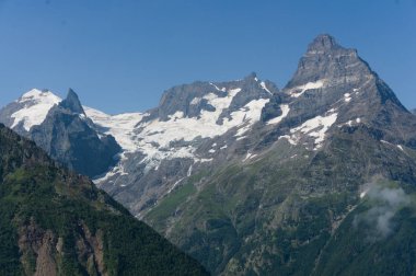 Siyah lar içinde, buzullar ve karla kaplı dağ zirvesi. Dombay, Rusya Federasyonu