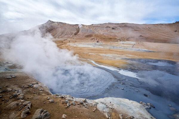 Hverir geothermal area in the north of Iceland near Lake Myvatn, with geothermal lake, looking like Blue Lagoon, Hot Mud Pots and great landscape in the Geothermal Area Hverir, summer day.