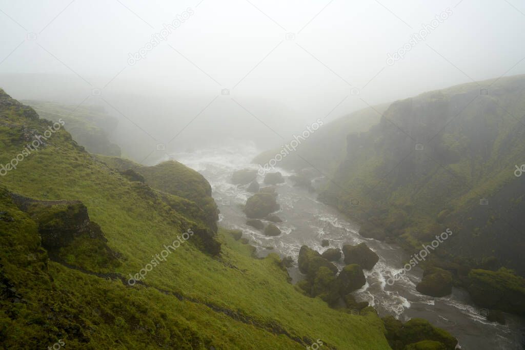 IWaterfall path hike from skogar to thorsmork on a rainy cloudy day in august 2020
