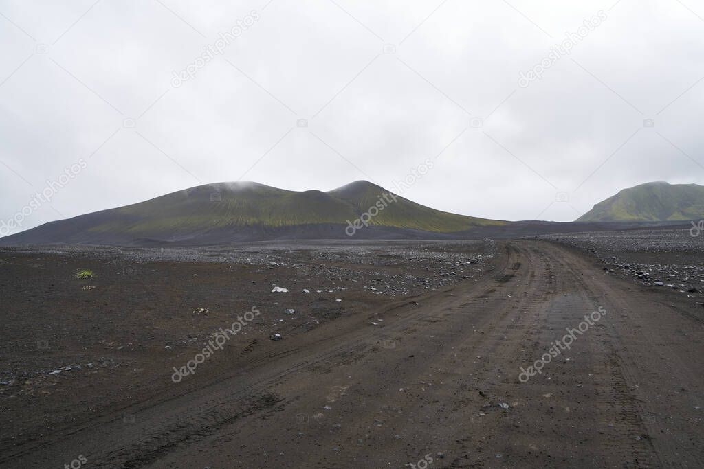 Vulcanic landscape in the highlands of iceland, black ash deserts with green moss