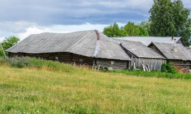 Kırsal peyzaj, odun ve sebze bahçeleri ile bir köy caddesinin arka tarafında. Eski ahşap evler ve sebze bahçeleri.