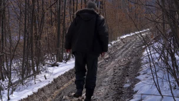 Człowiek Idzie Przez Mokry Las Ścieżka Śnieg Topi Się — Wideo stockowe