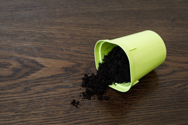 The plastic flower pot turned over and the earth poured out.