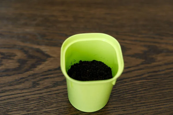 Plastic flower pot is half filled with earth — Stock Photo, Image