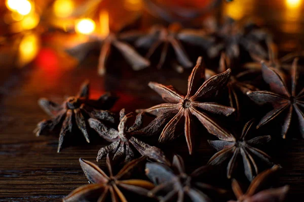 Anise on a wooden table with colorful backlighting — Stock Photo, Image