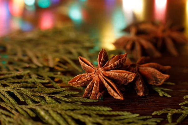 Anise on a wooden table with colorful backlighting. selective focus — Stock Photo, Image