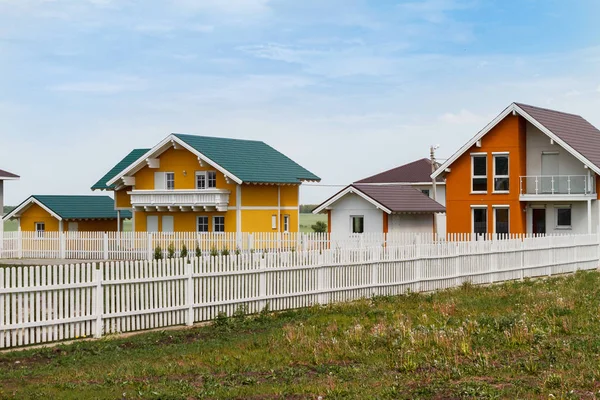 Modern small colored houses built in the countryside. — Stock Photo, Image