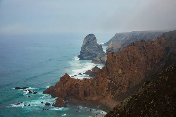 Kayalıklar Atlantik Okyanusu'nda sis kefen, Cascais kenti yakınlarındaki Cabo da Roca doğal manzara, Portekiz