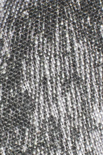 The texture of gray natural linen fabric with longitudinal threads located diagonally. Not uniform dyeing of the fibers. Abstract background. — Stock Photo, Image