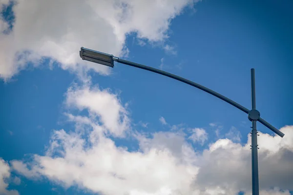 Modern street led lighting pole on blue sky background. Urban electric power technologies. Saving on street city road lighting.