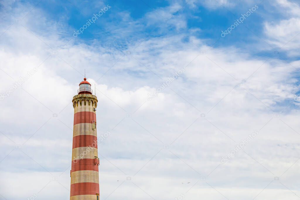 Praia da Barra lighthouse in Aveiro, Portugal. It is the highest lighthouse in Portugal with a height of 62 meters above the beach of the barrier and prone to Atlantic storms. Copy space