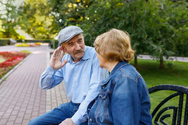 Elderly man tries to hear his spouse. The life of retirees. Hearing problems