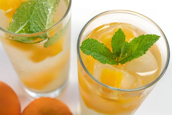 Fresh Cold Drink, Glasses of Water with Fruit Ice Cubes and Mint Leaves