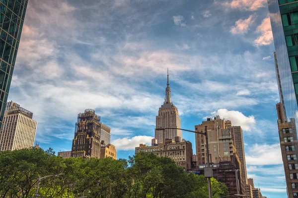 Ciudad de Nueva York. Empire State Building, Rascacielos y cielo azul nublado, Puesta del sol, Vista desde Bryant Park — Foto de Stock