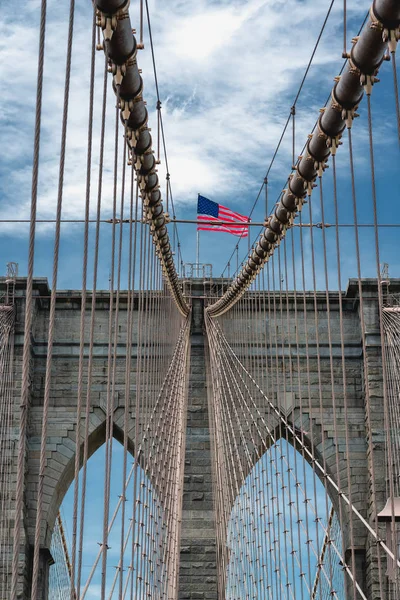 Brooklyn Bridge, New York City. American Flag, Cloudy Blue Sky, Vertical Banner