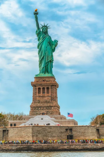 Statue of Liberty on Liberty Island, New York City. Cloudy Blue Sky Background, Vertical Banner